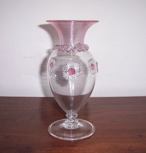 a victorian glass vase with cranberry trailing