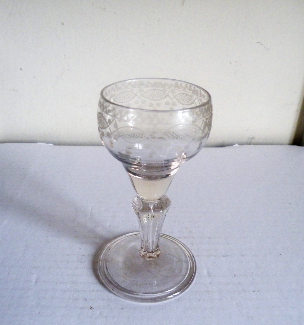 an18th century continental engraved wine glass with a pedestal stem
