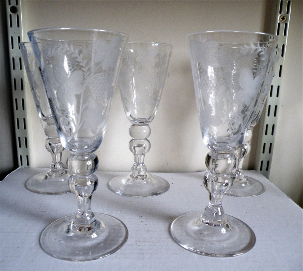 a very good set of five hand made engraved wine goblets