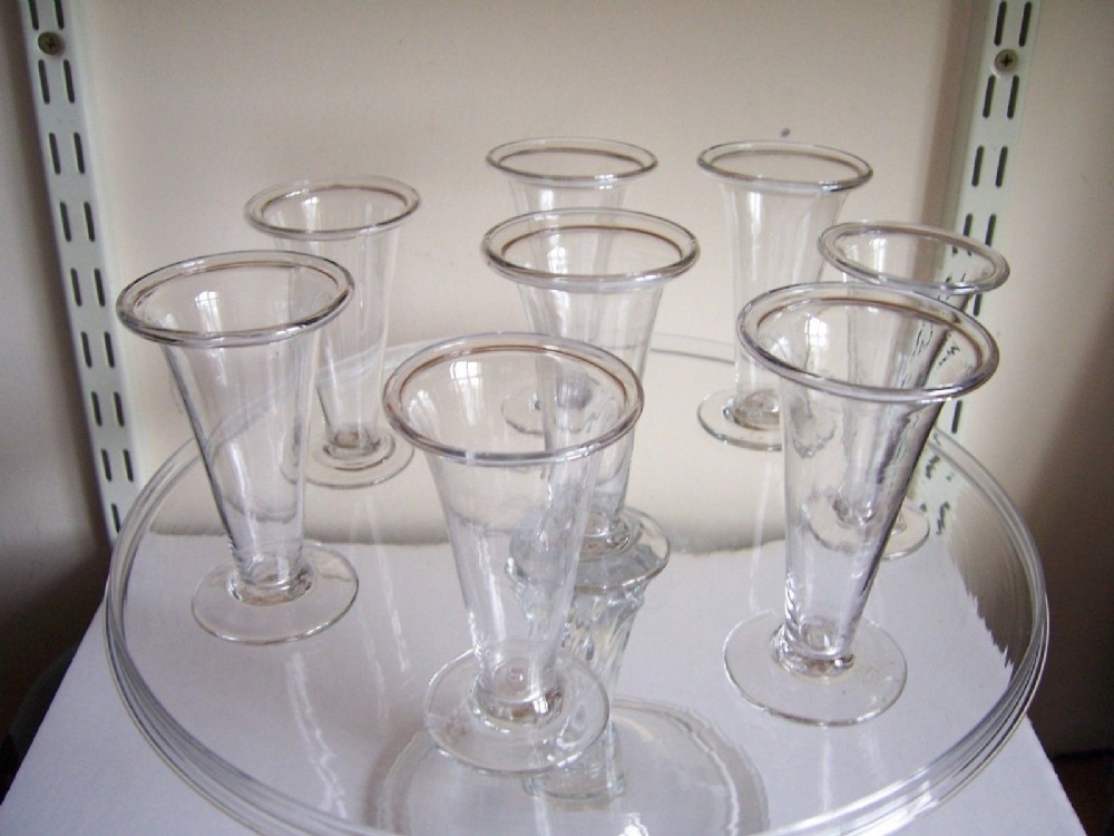 an extremely rare set of 8 early 18th century fold over rim jelly glasses 1720