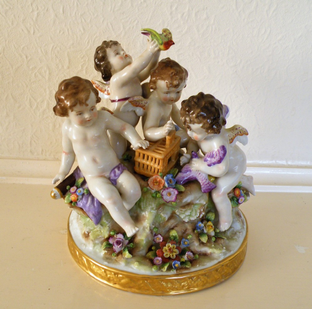 a charming 19th century naples porcelain group depicting winged cherubs with birds