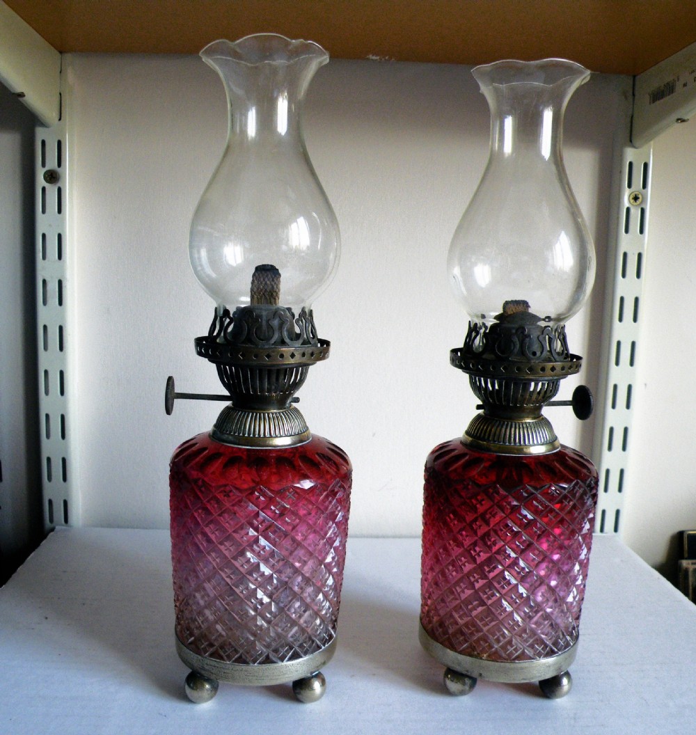 a pair of victorian cranberry glass table oil lamps