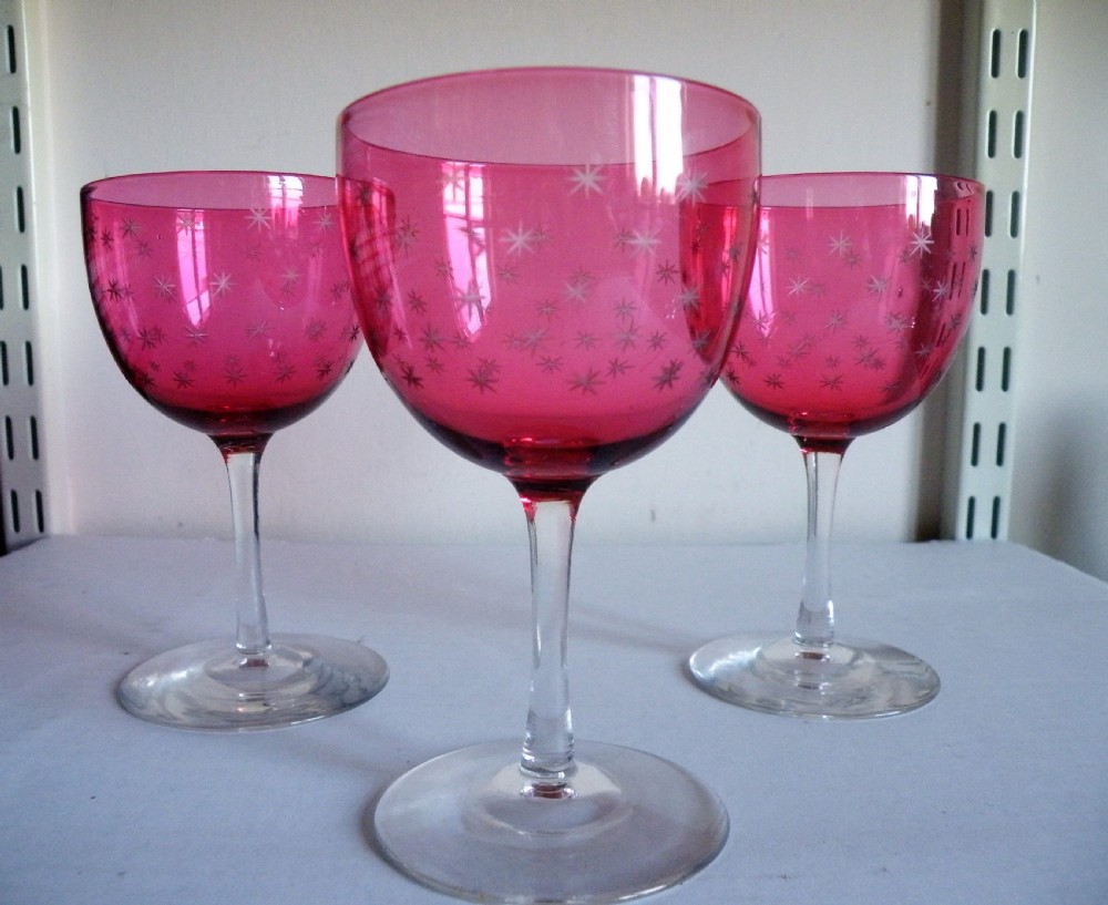 a nice trio of victorian star engraved bowl cranberry wine glasses