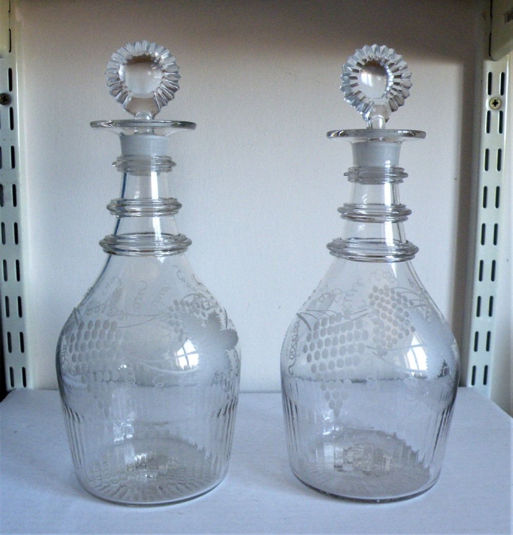 an extremely rare pair of irish 18th century engraved glass decanters