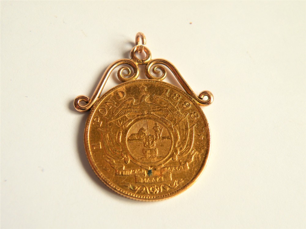 an 1898 solid gold pond pendant