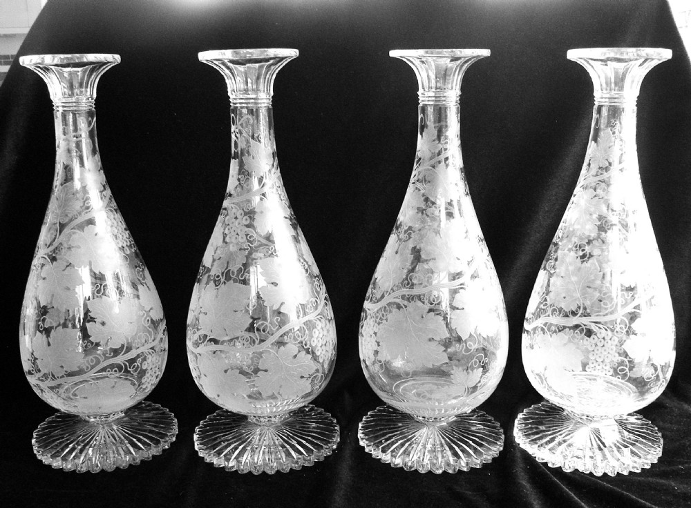a fine and rare set of four 19th century large vine engraved wine carafes